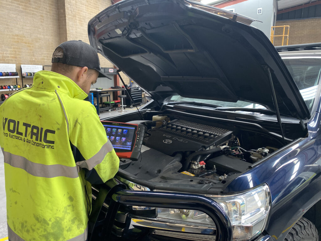 Auto Electrician working on vehicle