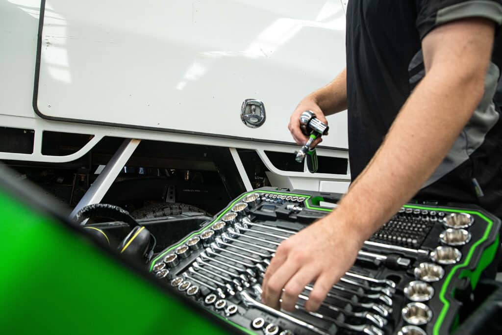 Close up of a professional Voltaic employee selecting a tool from the toolbox