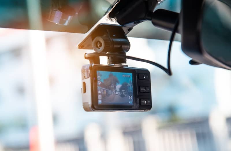 A dash cam is a small digital video recorder that attaches to your vehicles windscreen.