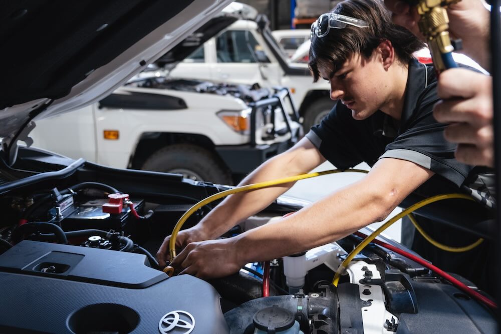 Auto electrician doing a car aircon service in our Welshpool workshop in Perth