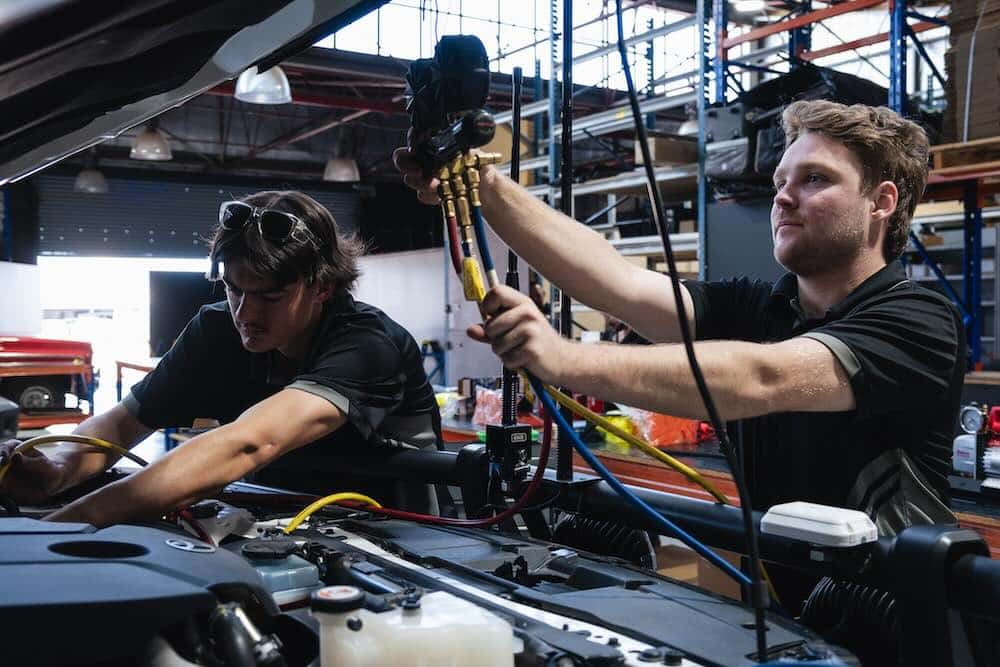 Auto electricians doing a car aircon regas in our Perth workshop