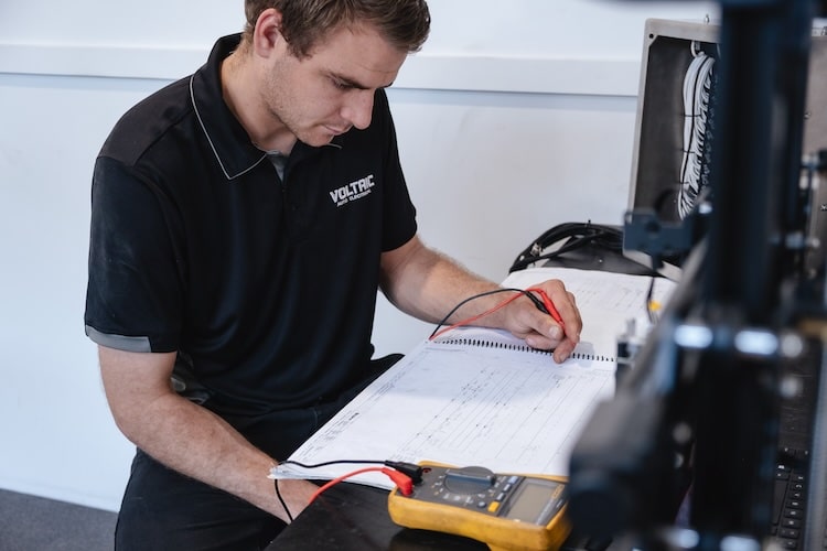 Car diagnostic being performed by an auto electrician