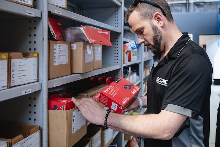 Auto electrician holding a REDARC Tow Pro