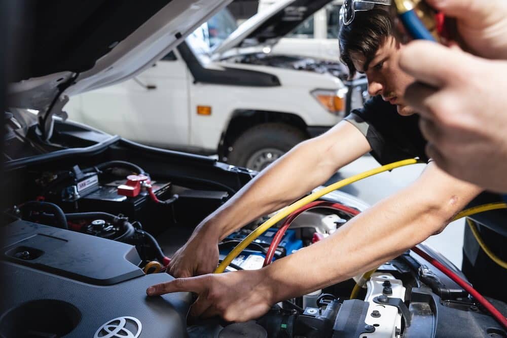 Auto electricians fixing broker car heater
