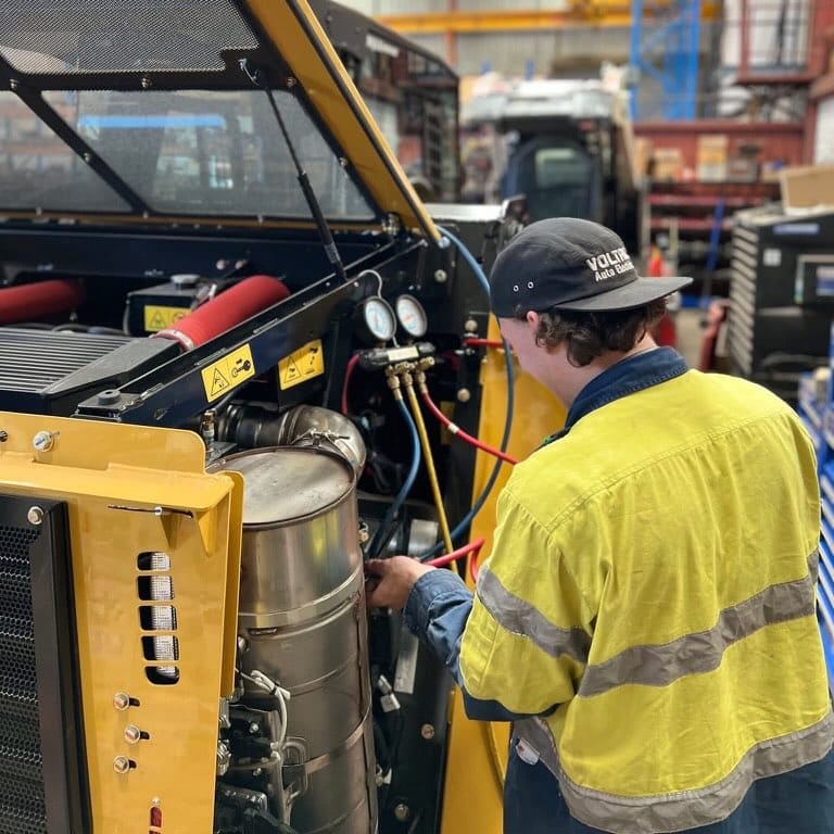 Voltaic fleet service technician inspecting a vehicle