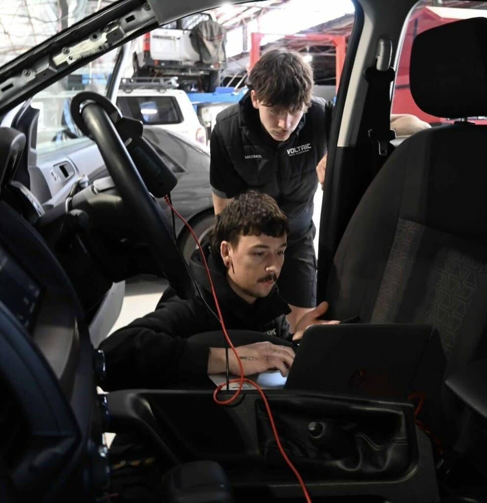 Auto diagnostic team inspecting a vehicle